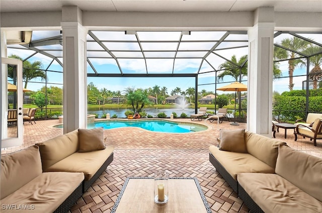 view of pool featuring an outdoor hangout area, a water view, and glass enclosure