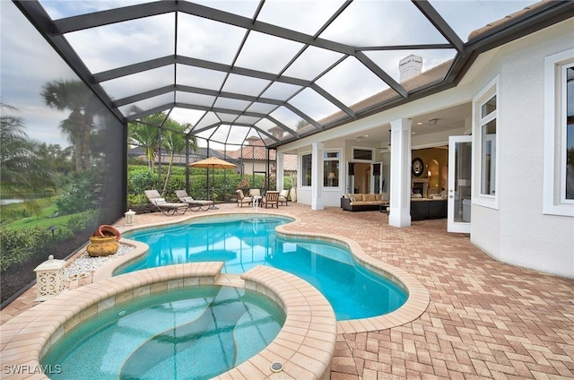 view of swimming pool with a lanai, an in ground hot tub, a patio, and an outdoor hangout area