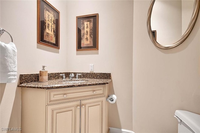 bathroom featuring vanity and toilet