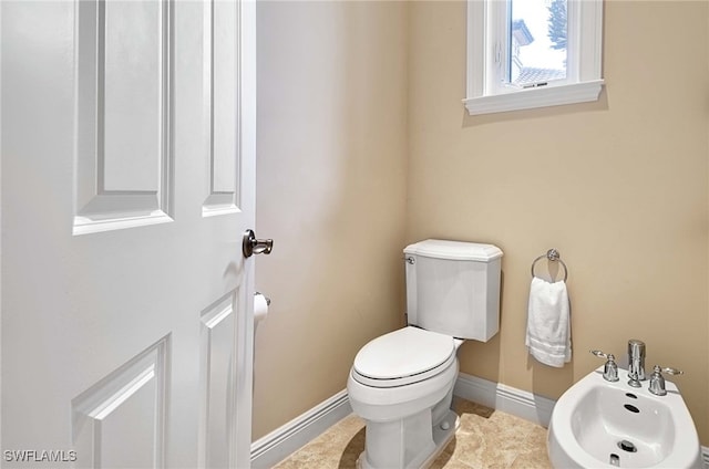 bathroom with toilet and a bidet