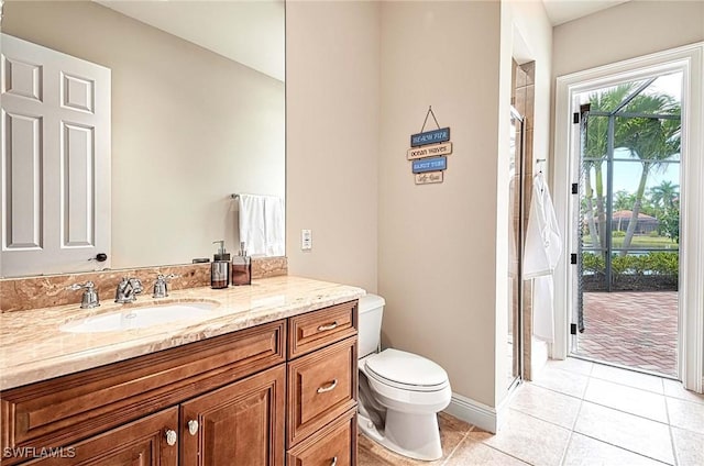 bathroom featuring tile patterned flooring, vanity, toilet, and a shower with door