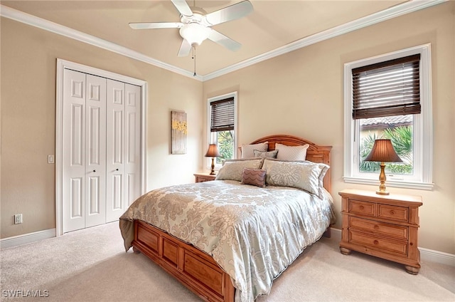 bedroom featuring a closet, multiple windows, light colored carpet, and ceiling fan