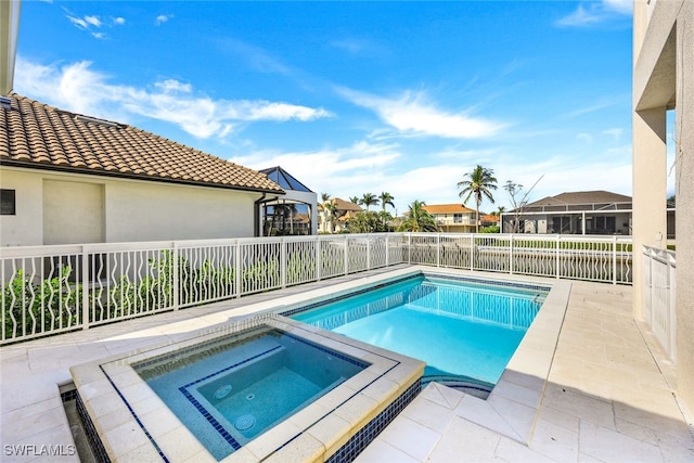 view of swimming pool with an in ground hot tub and a patio area