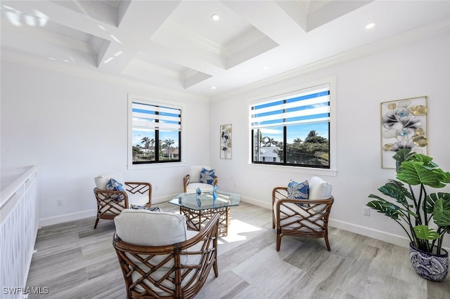 living area with a wealth of natural light, crown molding, and light hardwood / wood-style flooring