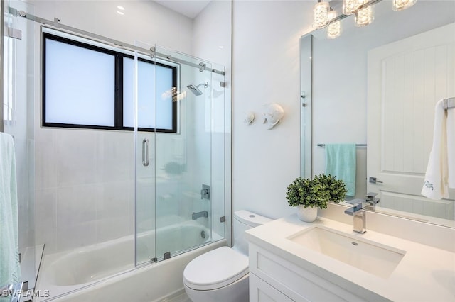 full bathroom with vanity, combined bath / shower with glass door, and toilet