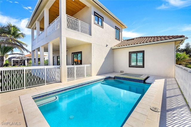 view of swimming pool with an in ground hot tub