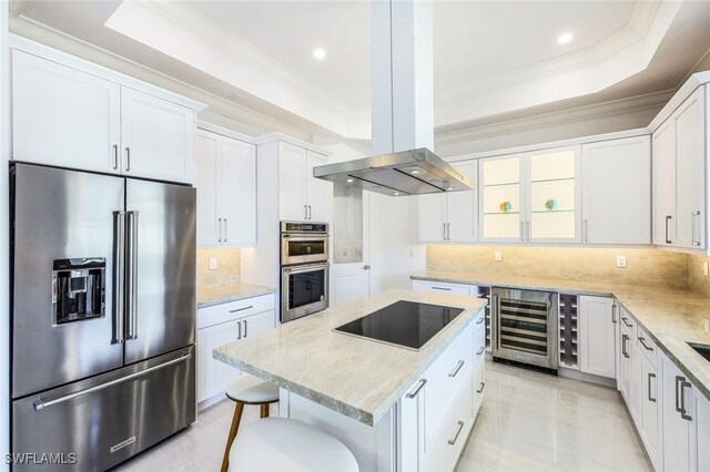 kitchen featuring island range hood, beverage cooler, white cabinets, and stainless steel appliances