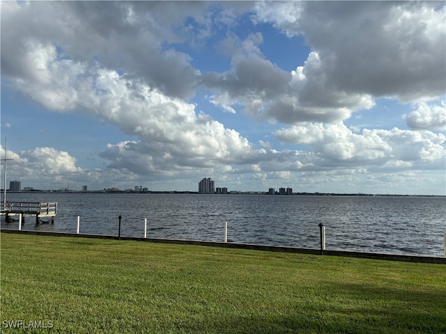 dock area featuring a yard and a water view