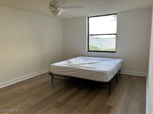 bedroom featuring ceiling fan and dark wood-type flooring