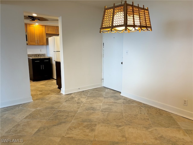 unfurnished dining area featuring ceiling fan