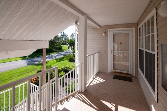 view of exterior entry featuring covered porch