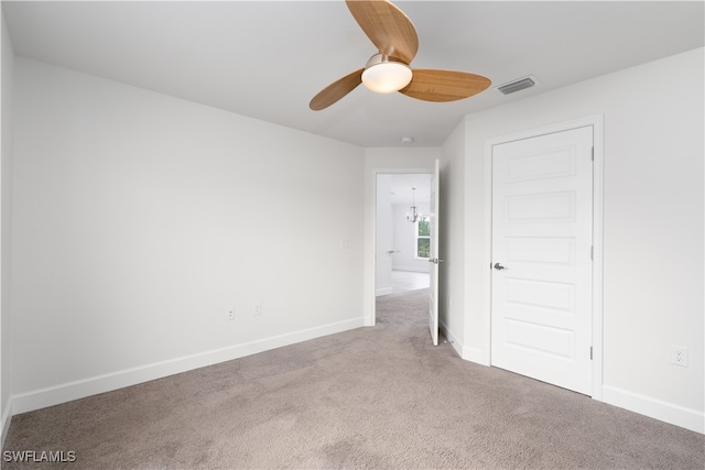 spare room featuring ceiling fan and carpet floors