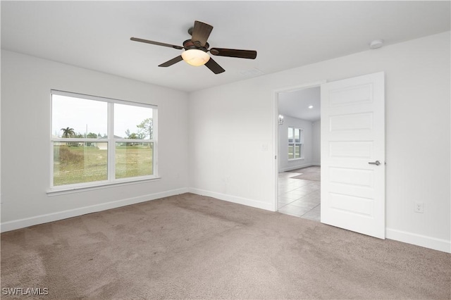 carpeted spare room with ceiling fan