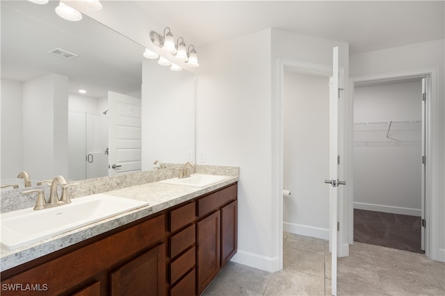 bathroom featuring tile patterned floors, vanity, and an enclosed shower