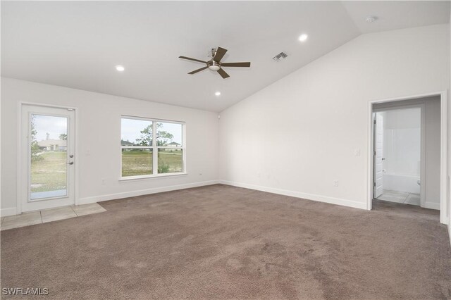 carpeted spare room featuring ceiling fan and high vaulted ceiling