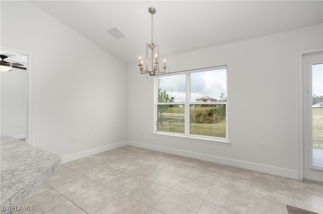 unfurnished dining area with ceiling fan with notable chandelier, lofted ceiling, and light tile patterned floors