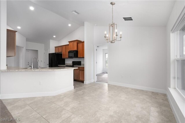 kitchen featuring black appliances, sink, hanging light fixtures, a notable chandelier, and kitchen peninsula