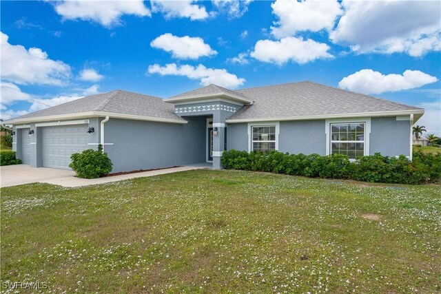 view of front of house featuring a front lawn and a garage