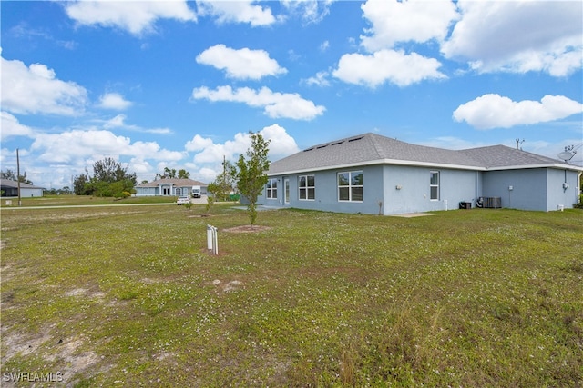 exterior space featuring a lawn and central AC