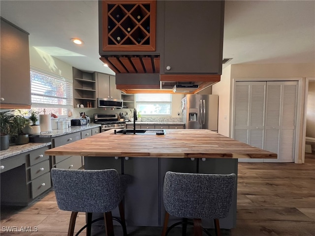 kitchen with plenty of natural light, a kitchen island, and appliances with stainless steel finishes