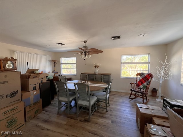 dining space featuring hardwood / wood-style flooring, ceiling fan, and plenty of natural light