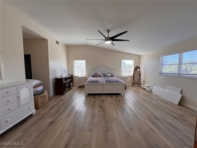 bedroom featuring light hardwood / wood-style floors, ceiling fan, and vaulted ceiling