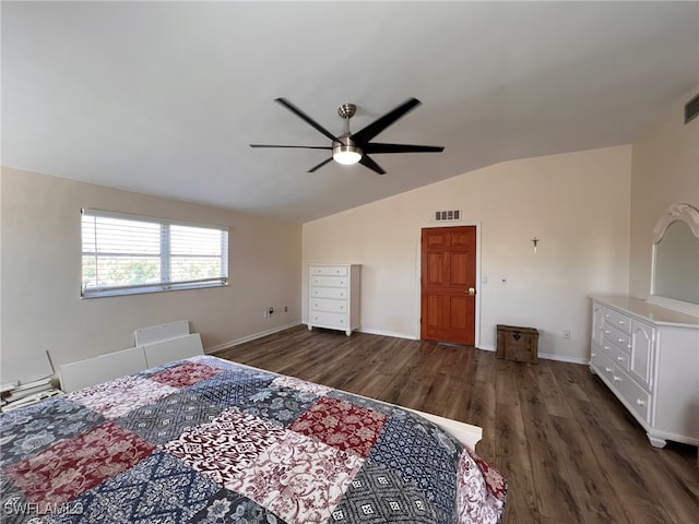 bedroom with dark hardwood / wood-style flooring, vaulted ceiling, and ceiling fan