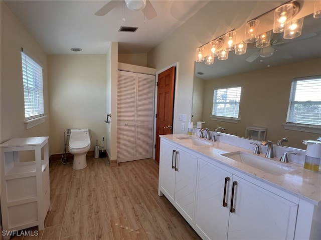 bathroom featuring hardwood / wood-style floors, plenty of natural light, toilet, and vanity