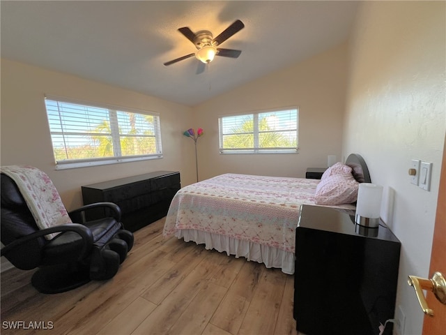 bedroom with ceiling fan, lofted ceiling, and light hardwood / wood-style floors