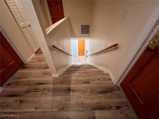 staircase with hardwood / wood-style flooring