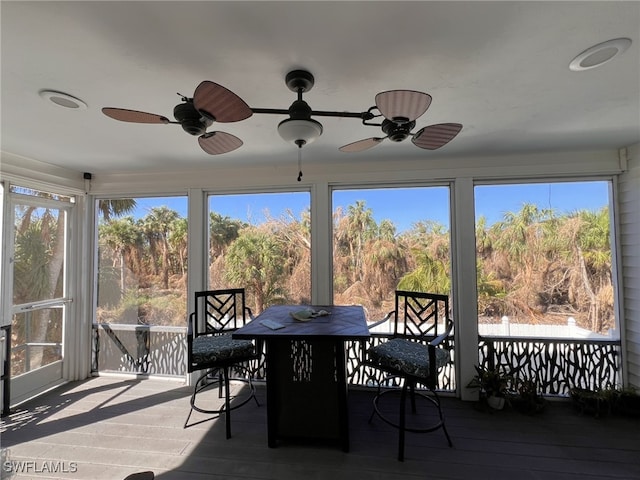 sunroom with a healthy amount of sunlight and ceiling fan