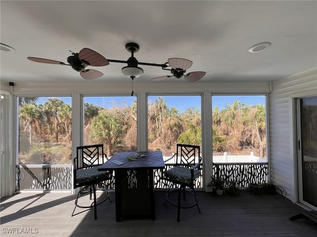 sunroom featuring ceiling fan