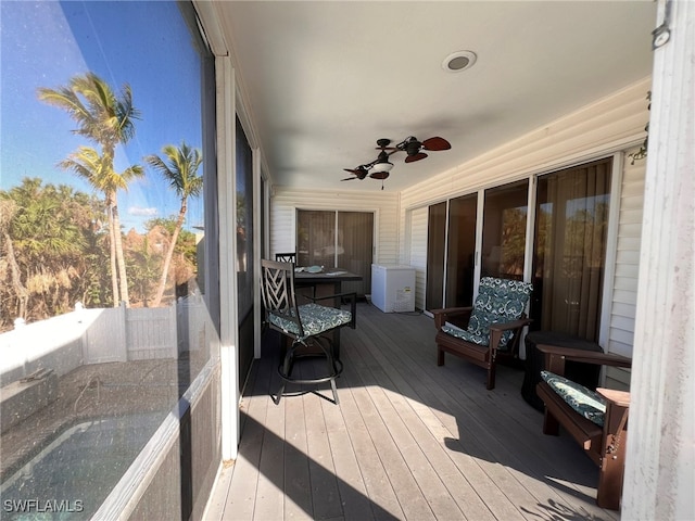 sunroom featuring ceiling fan