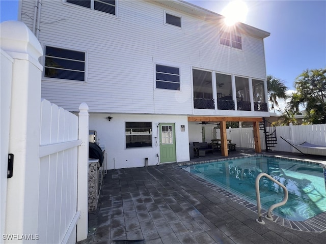 view of pool with a patio and a sunroom