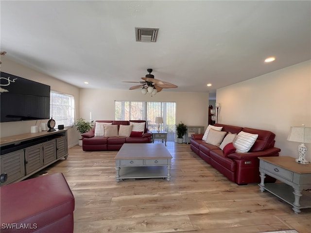 living room with ceiling fan and light wood-type flooring