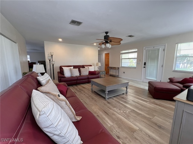 living room featuring ceiling fan, a wealth of natural light, and light hardwood / wood-style floors