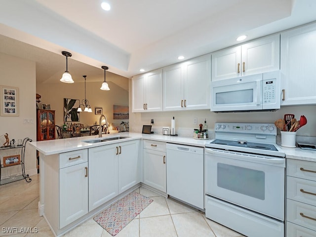 kitchen with kitchen peninsula, white cabinetry, sink, and white appliances