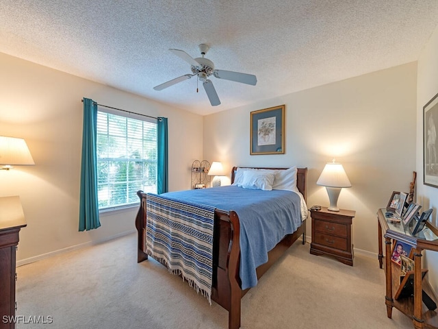 carpeted bedroom featuring ceiling fan and a textured ceiling