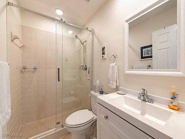 bathroom featuring walk in shower, vanity, and toilet