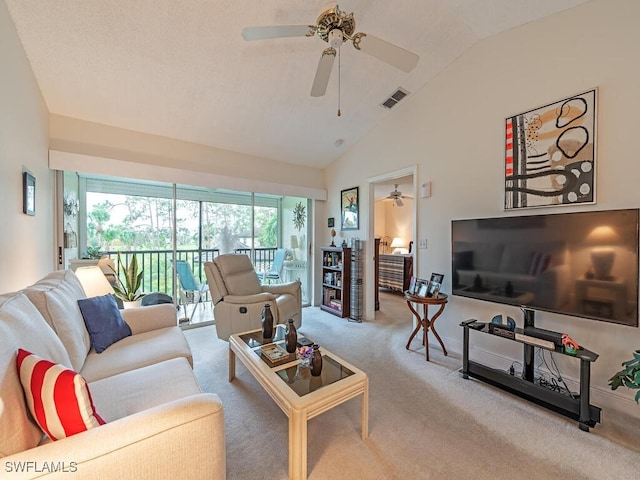 carpeted living room with ceiling fan and lofted ceiling