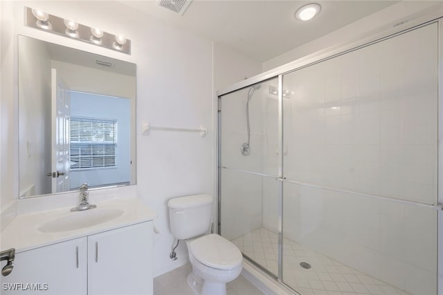 bathroom featuring walk in shower, tile patterned floors, vanity, and toilet