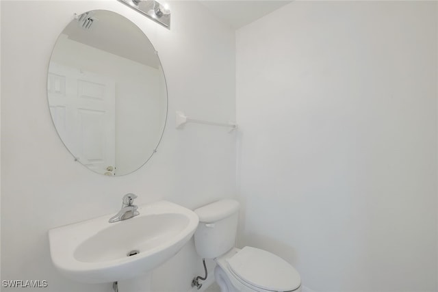 bathroom with toilet and sink