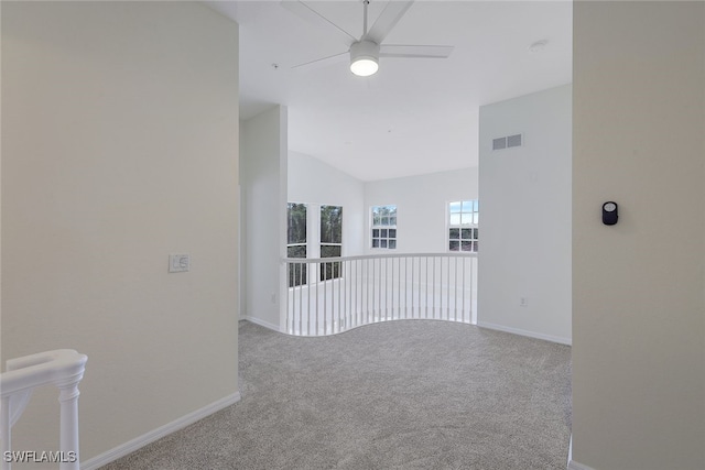 carpeted empty room with lofted ceiling and ceiling fan