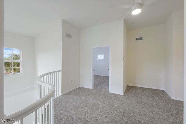 unfurnished room with light colored carpet