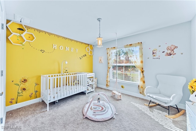 bedroom with carpet flooring and a nursery area