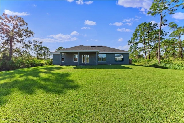 3002 40th St W, Lehigh Acres, FL 33971 - back of house featuring a lawn and stucco siding