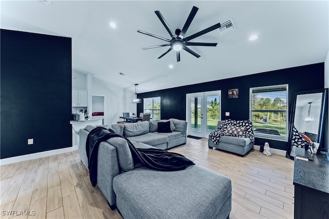 living room with ceiling fan, french doors, light wood-type flooring, and lofted ceiling