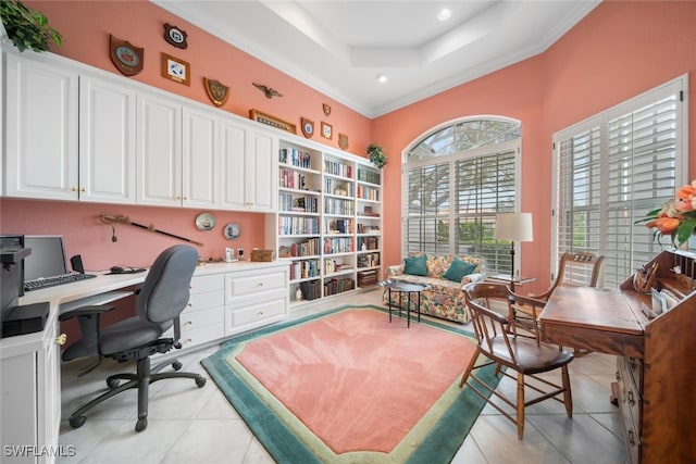 office featuring built in desk, light tile patterned floors, crown molding, and a tray ceiling