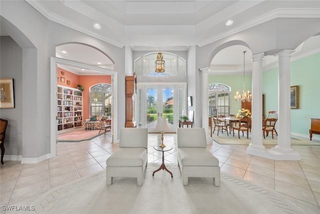 sitting room featuring ornamental molding, light tile patterned floors, and an inviting chandelier