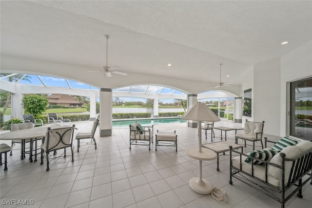 view of patio with glass enclosure and ceiling fan